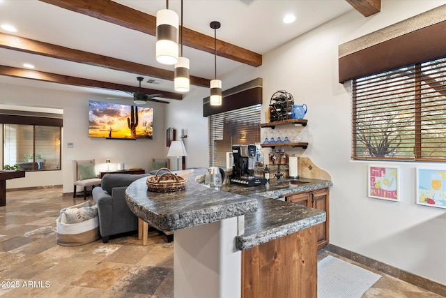 kitchen featuring kitchen peninsula, dark stone counters, ceiling fan, beam ceiling, and hanging light fixtures