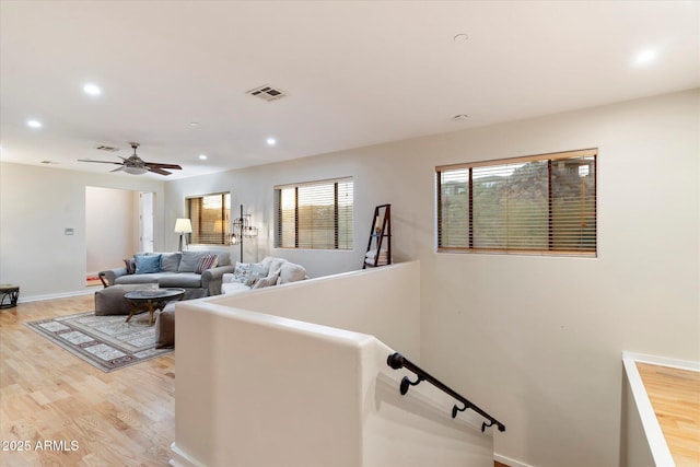 interior space with ceiling fan and hardwood / wood-style floors