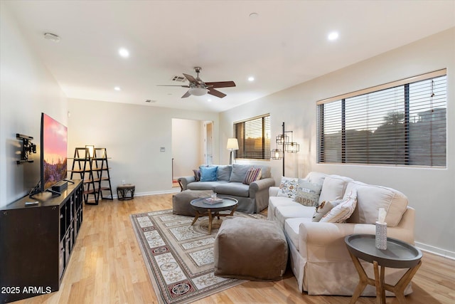 living room with ceiling fan and light wood-type flooring