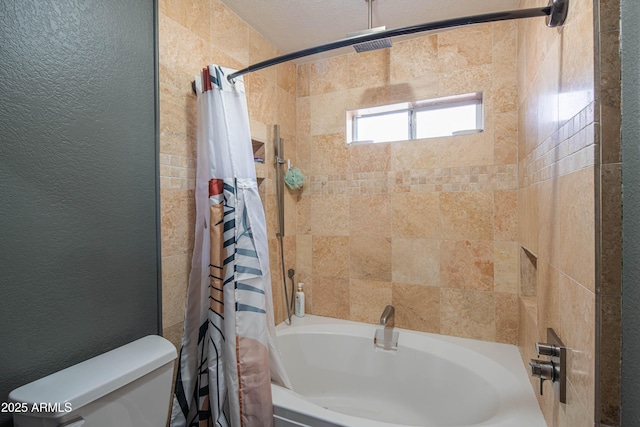 full bath featuring toilet, shower / bath combo, and a textured wall