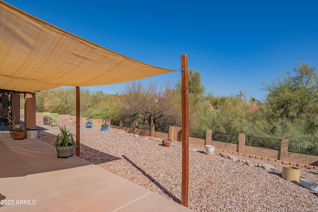 view of yard featuring a patio and fence