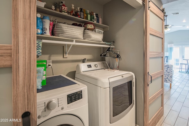 clothes washing area with a ceiling fan, visible vents, laundry area, separate washer and dryer, and a barn door