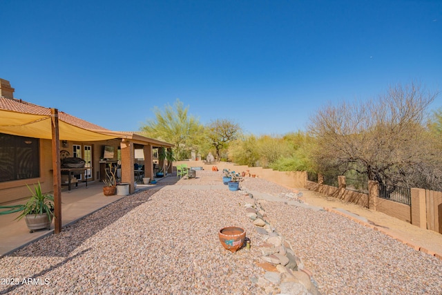 view of yard with a patio and fence