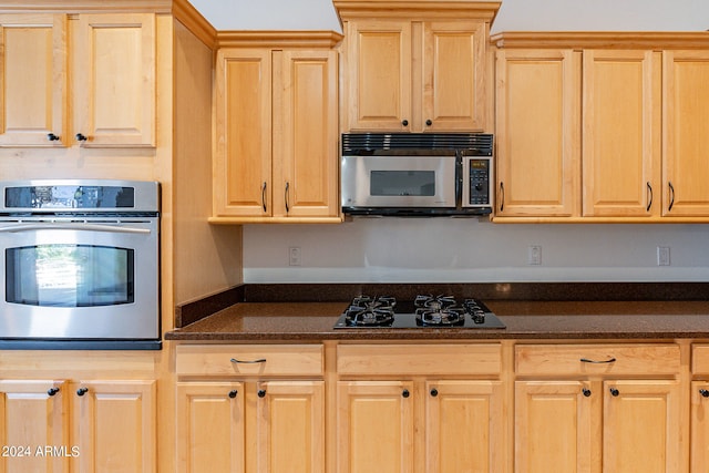 kitchen with light brown cabinets and stainless steel appliances