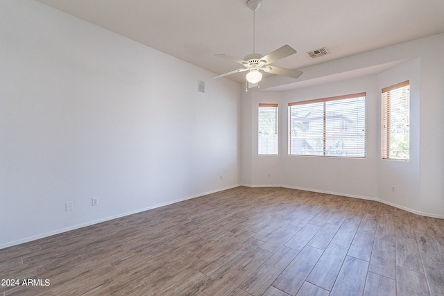 unfurnished room with ceiling fan and hardwood / wood-style flooring