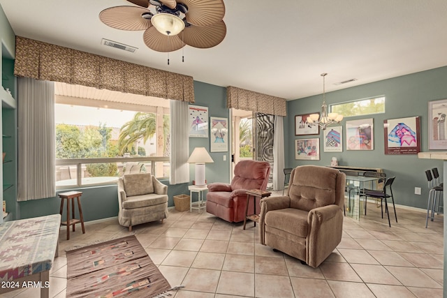 sitting room featuring light tile patterned floors and ceiling fan with notable chandelier