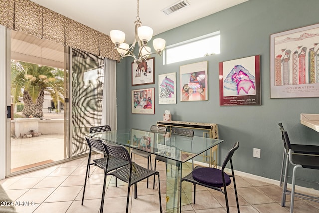 dining area with tile patterned floors and a chandelier