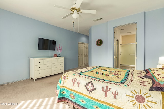 bedroom featuring light carpet, a closet, ceiling fan, and ensuite bathroom