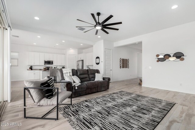 3089 N 200th Ave, Buckeye, AZ 85396 - living room featuring a ceiling fan, light wood-style floors, recessed lighting, and baseboards