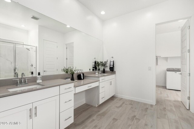 3089 N 200th Ave, Buckeye, AZ 85396 - full bathroom featuring washer / dryer, wood finished floors, a shower stall, vanity, and recessed lighting
