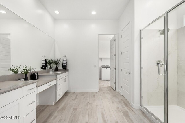 3089 N 200th Ave, Buckeye, AZ 85396 - bathroom featuring wood finished floors, a marble finish shower, vanity, washer / dryer, and recessed lighting