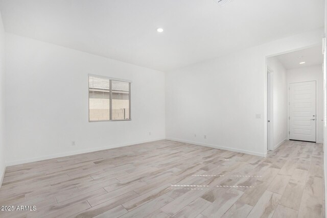 3089 N 200th Ave, Buckeye, AZ 85396 - empty room featuring light wood-type flooring, baseboards, and recessed lighting