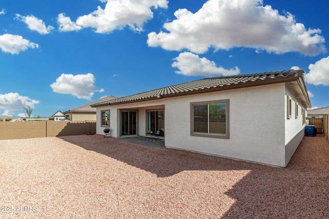 3089 N 200th Ave, Buckeye, AZ 85396 - back of property featuring stucco siding, a fenced backyard, a patio, and a tiled roof