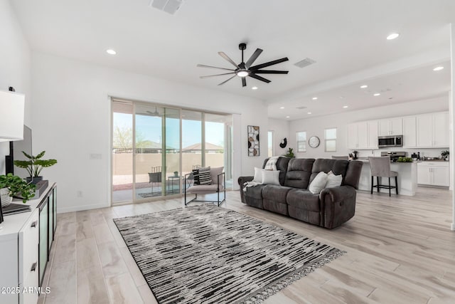 3089 N 200th Ave, Buckeye, AZ 85396 - living room featuring ceiling fan, light wood-style flooring, recessed lighting, and baseboards