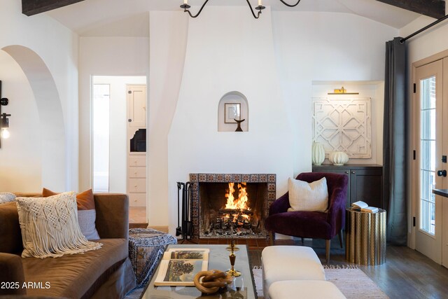 1309 W Lynwood St, Phoenix, AZ 85007 - living room with arched walkways, wood finished floors, a warm lit fireplace, and lofted ceiling