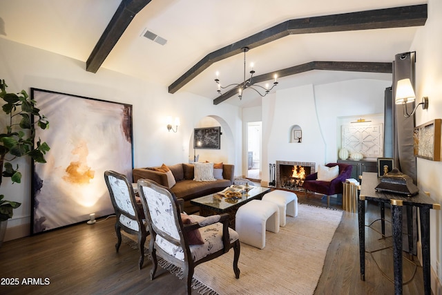 1309 W Lynwood St, Phoenix, AZ 85007 - living area with arched walkways, a chandelier, wood finished floors, and a fireplace