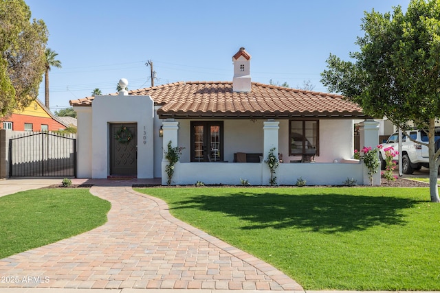 1309 W Lynwood St, Phoenix, AZ 85007 - mediterranean / spanish home featuring stucco siding, a front lawn, a tiled roof, a gate, and a chimney