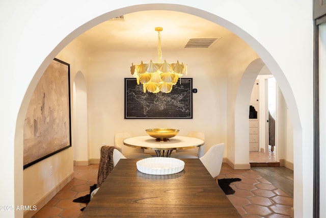 1309 W Lynwood St, Phoenix, AZ 85007 - tiled dining space featuring a chandelier and baseboards