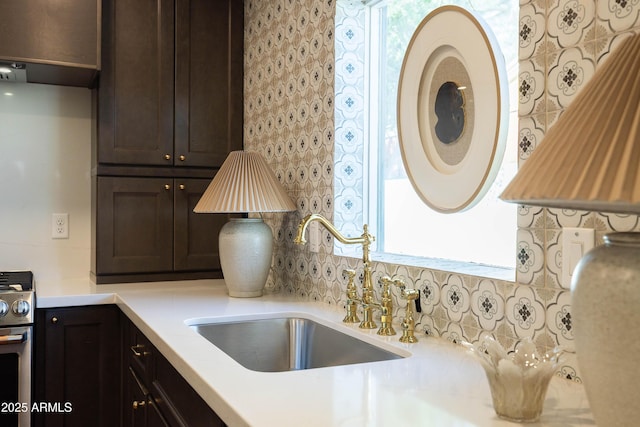 1309 W Lynwood St, Phoenix, AZ 85007 - kitchen with stainless steel electric range, dark brown cabinetry, a sink, light countertops, and tasteful backsplash