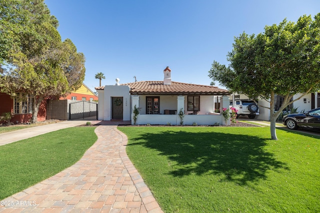 1309 W Lynwood St, Phoenix, AZ 85007 - view of front of home featuring a gate, a tiled roof, a chimney, concrete driveway, and stucco siding