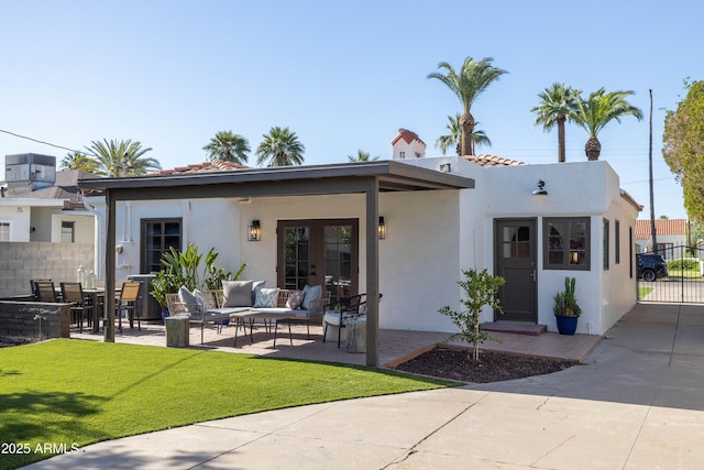 1309 W Lynwood St, Phoenix, AZ 85007 - rear view of house with stucco siding, a patio area, an outdoor living space, french doors, and a tiled roof