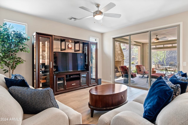 living room with ceiling fan and light wood-type flooring