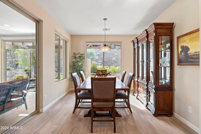 dining space with light hardwood / wood-style floors