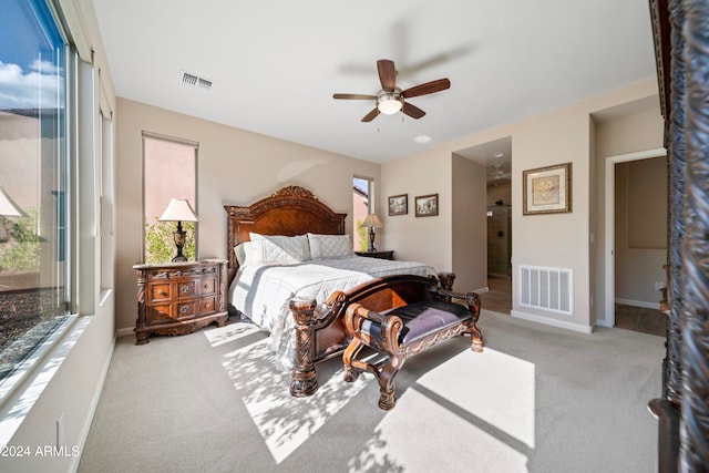 bedroom with ceiling fan and light colored carpet