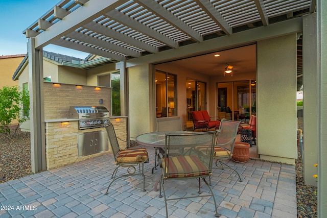 view of patio / terrace with a pergola, area for grilling, and exterior kitchen