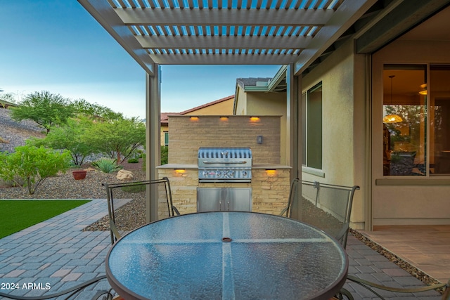 view of patio / terrace featuring area for grilling and a pergola