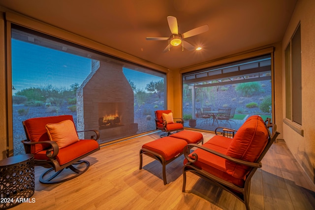 sunroom / solarium featuring ceiling fan