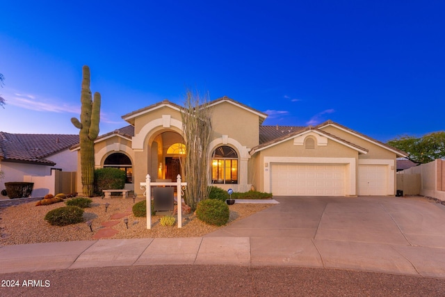 mediterranean / spanish house featuring a garage