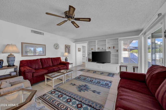 tiled living room featuring a textured ceiling, built in features, and ceiling fan