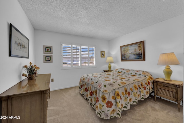 carpeted bedroom with a textured ceiling