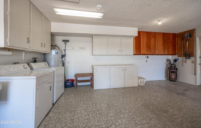 washroom featuring cabinets, separate washer and dryer, a textured ceiling, and water heater