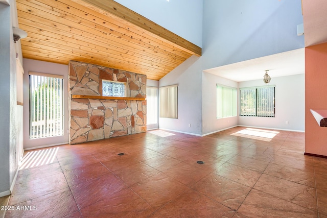 interior space with wooden ceiling, baseboards, and high vaulted ceiling