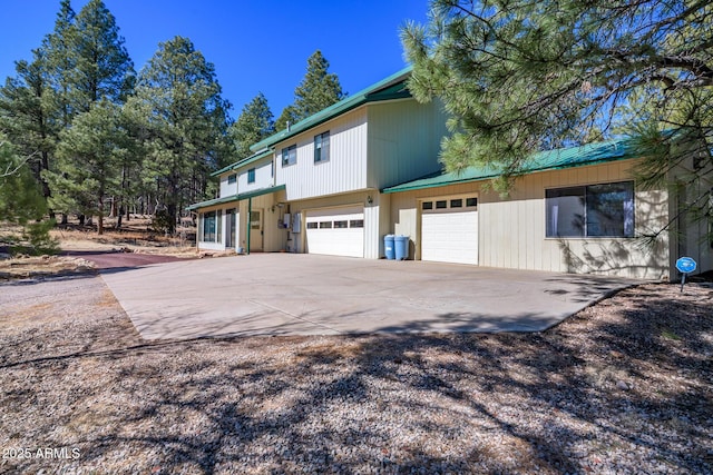 view of side of home featuring driveway and a garage