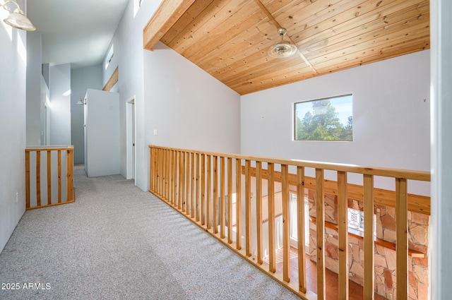 hallway featuring wood ceiling, carpet, and lofted ceiling