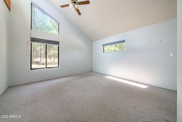 carpeted empty room featuring high vaulted ceiling and ceiling fan