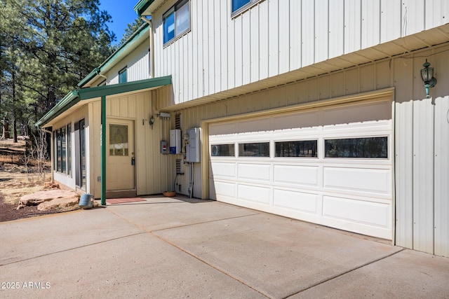 view of side of home featuring driveway and an attached garage