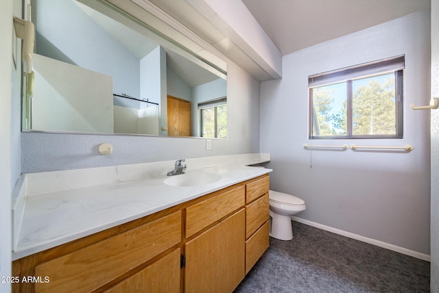 bathroom featuring baseboards, toilet, vanity, and vaulted ceiling