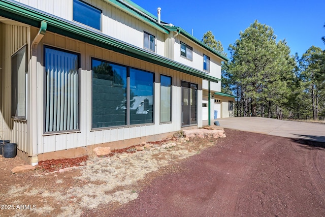 view of side of home featuring driveway