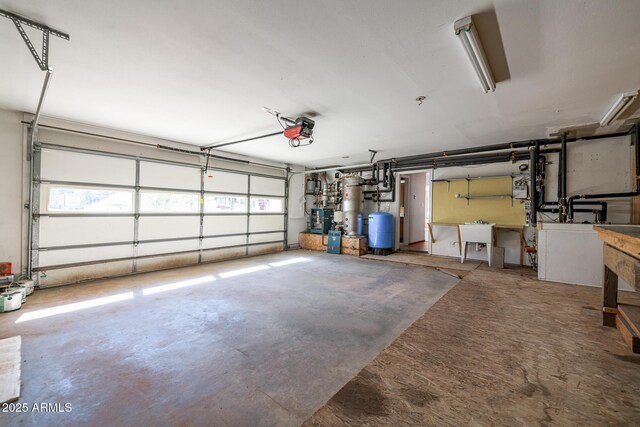 garage featuring a garage door opener and a sink