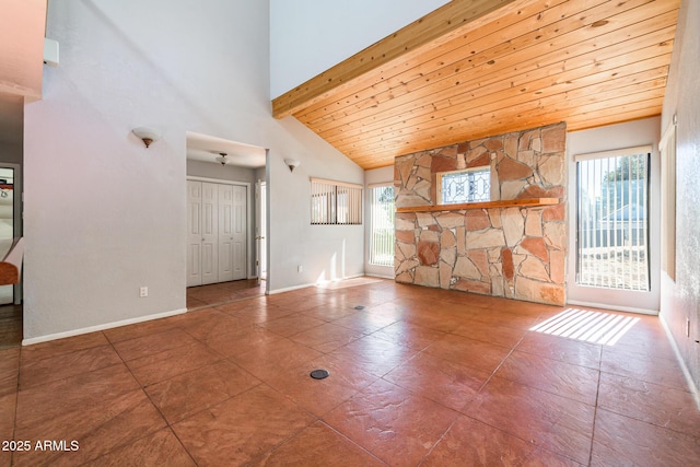 unfurnished living room with baseboards, high vaulted ceiling, beam ceiling, wooden ceiling, and tile patterned floors