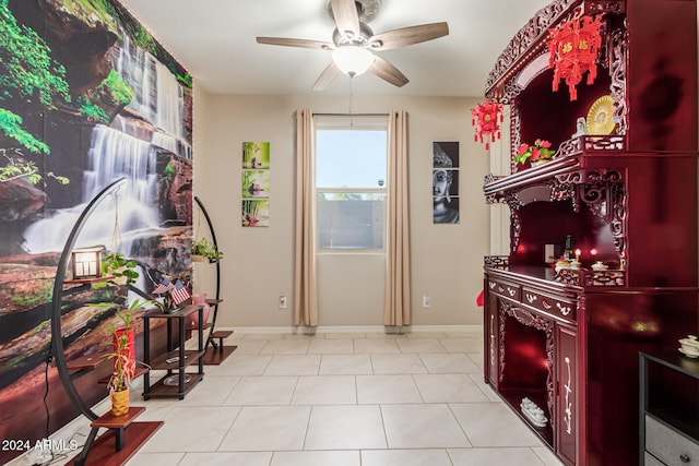 interior space featuring light tile patterned floors and ceiling fan