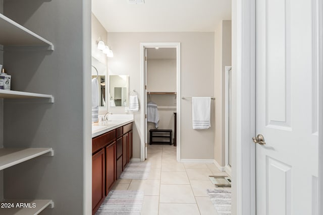 bathroom with vanity, a shower with shower door, and tile patterned flooring