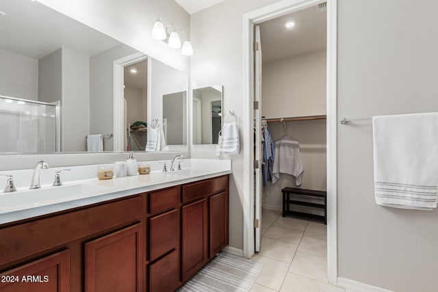 bathroom featuring vanity, tile patterned flooring, and an enclosed shower