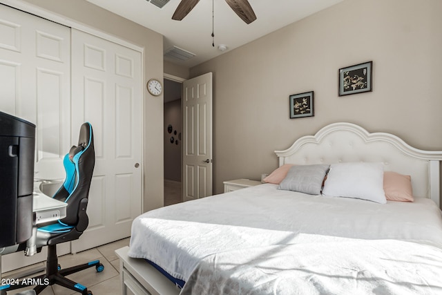 tiled bedroom with a closet and ceiling fan