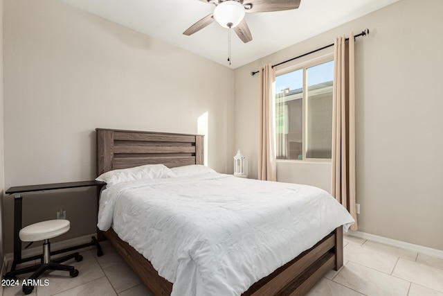 tiled bedroom featuring ceiling fan