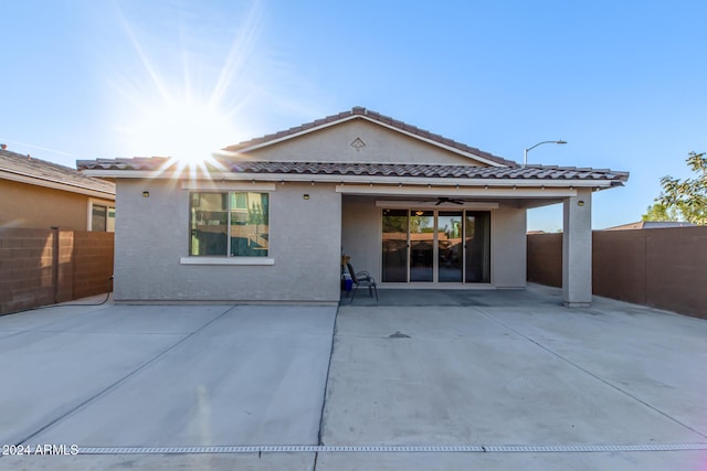 rear view of house featuring a patio and ceiling fan